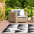 A black and white, customised outdoor rug in the context of an outdoor seating area. Shop now to brighten up your outdoor space!