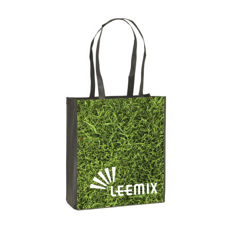 A shopping bag with a photo of green grass printed on the side, available at Helloprint for a cheap price